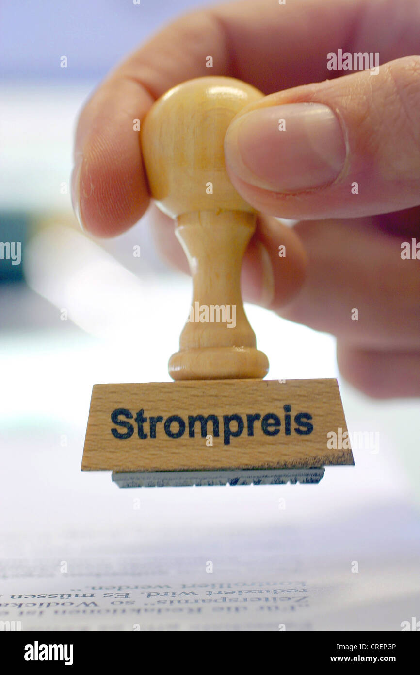 hand with a stamp Strompreis, electricity tariff Stock Photo