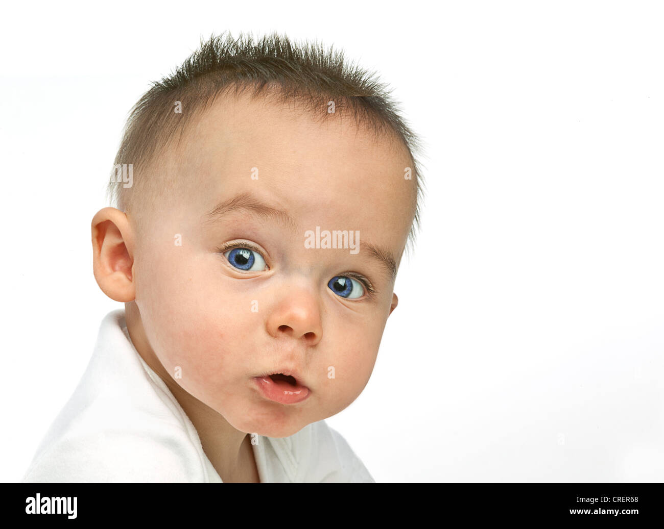 8 month old baby boy with spiky hair and a challenging expression, dressed  in a white vest Stock Photo - Alamy