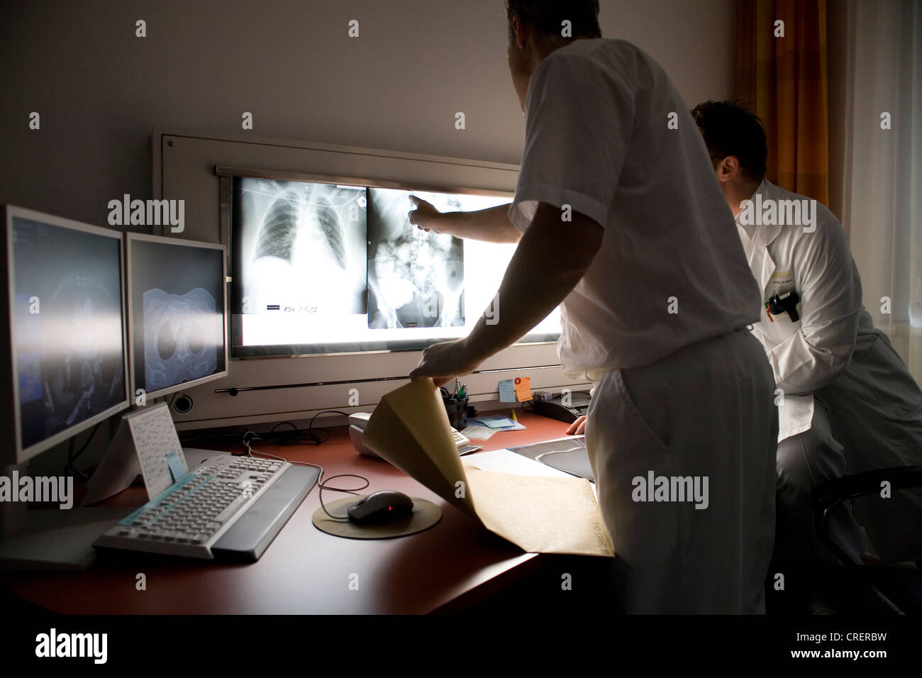 doctors talking about the finding Stock Photo - Alamy