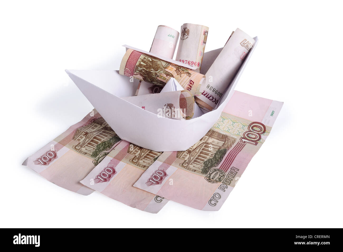 Paper boat on the money isolated on a white background Stock Photo