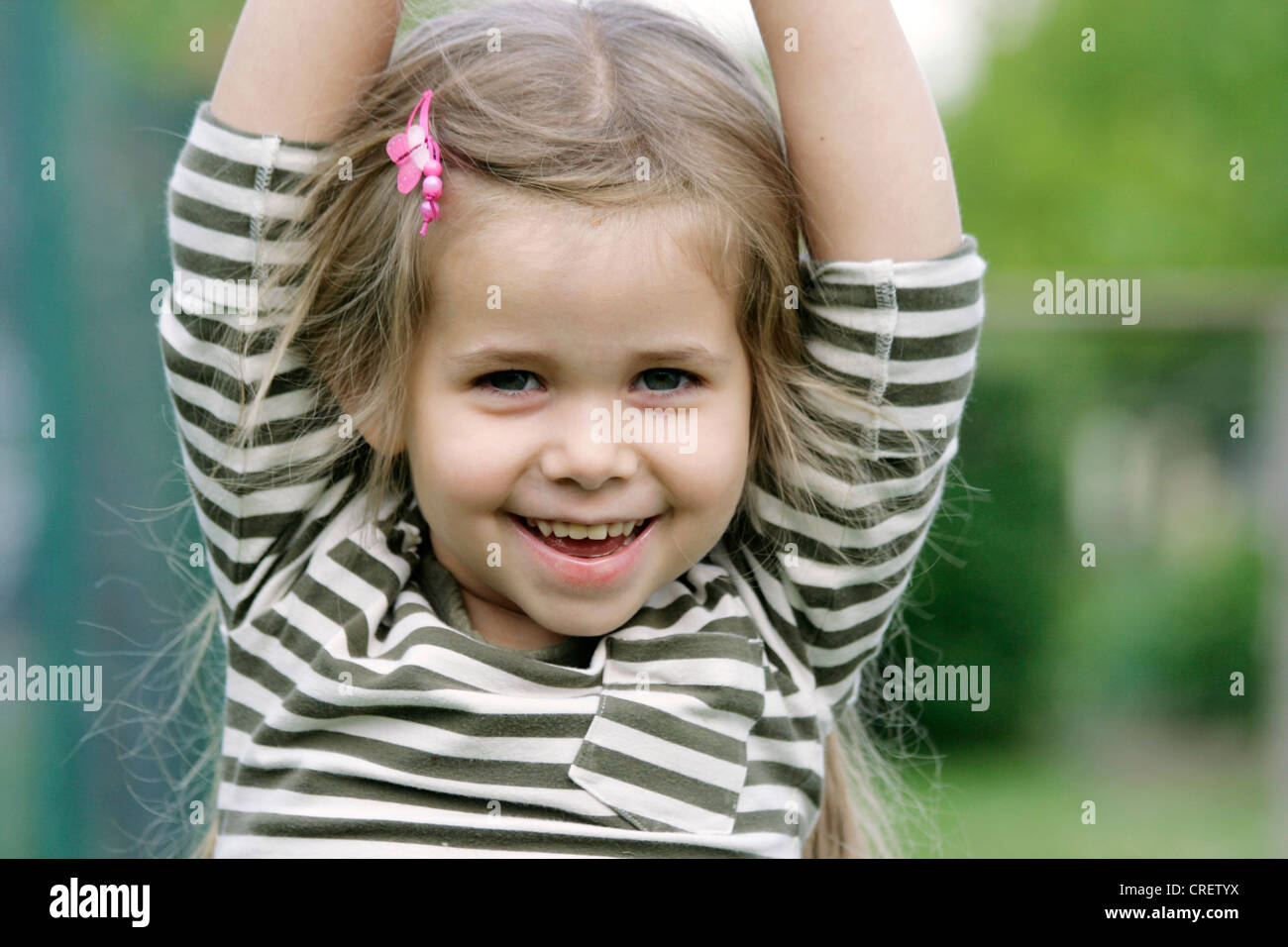 small blond, smiling girl having fun, Germany Stock Photo