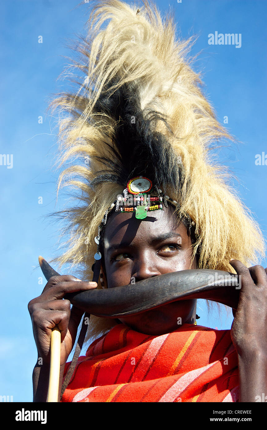 Portrait of a boy playing on a traditional Kenyan musical instrument