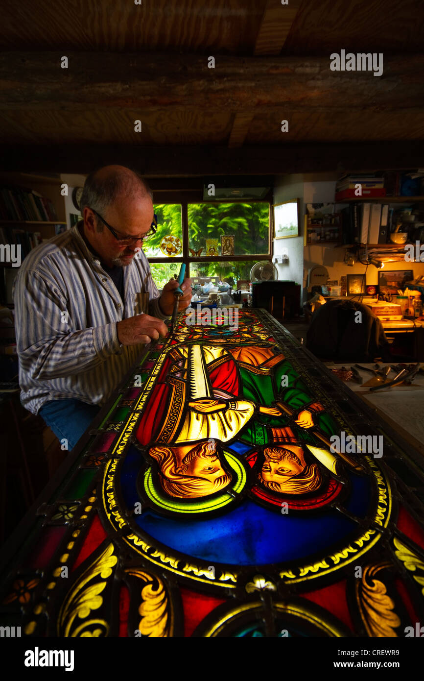 Stained Glass Window maker Repairing Cornish church window Stock Photo