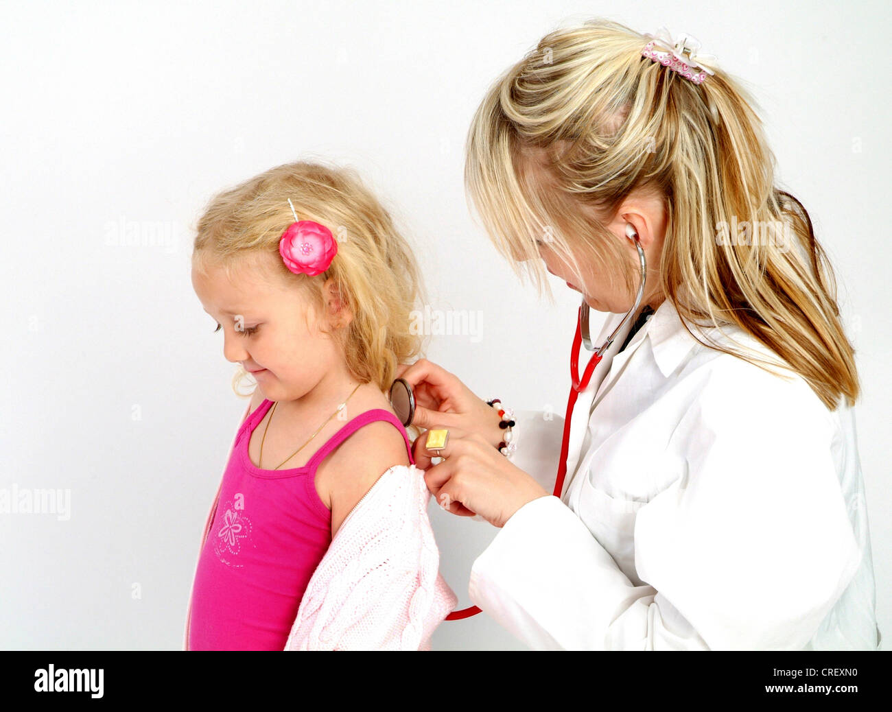 pediatrician cheking girl with stethoscope Stock Photo