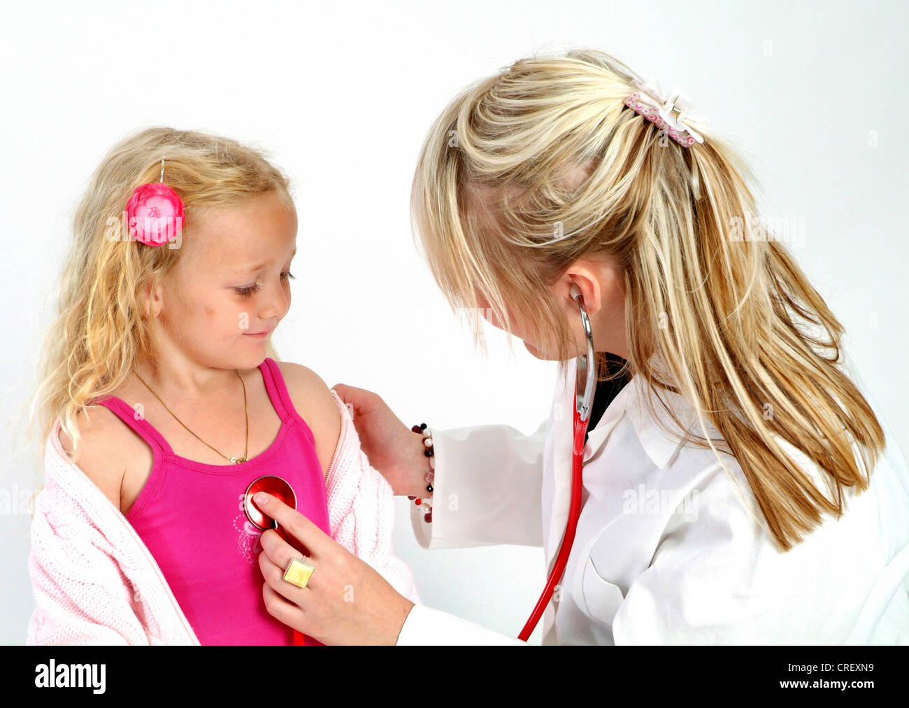 pediatrician cheking girl with stethoscope Stock Photo