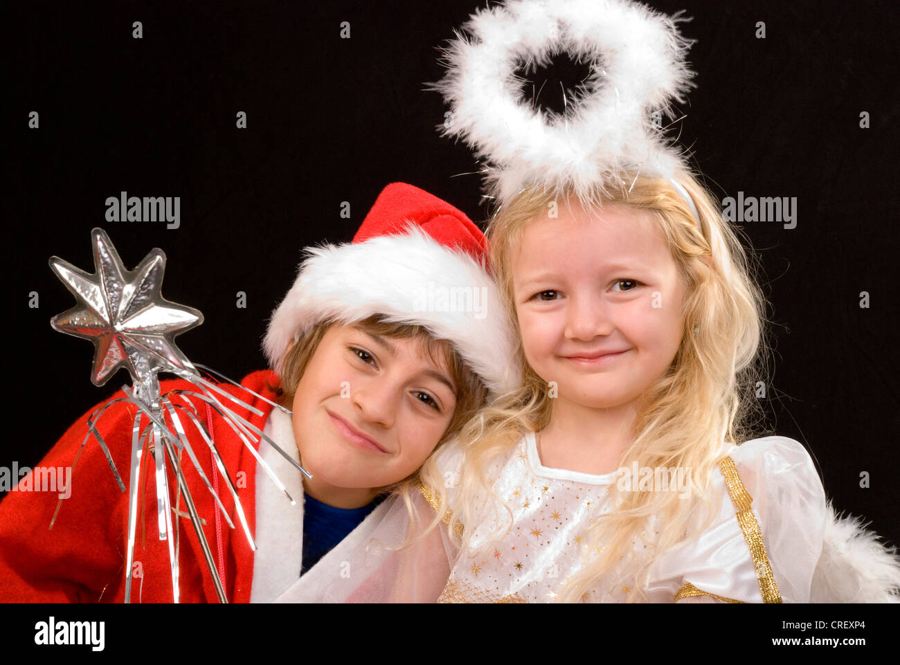 children as Santa Claus and christ child Stock Photo