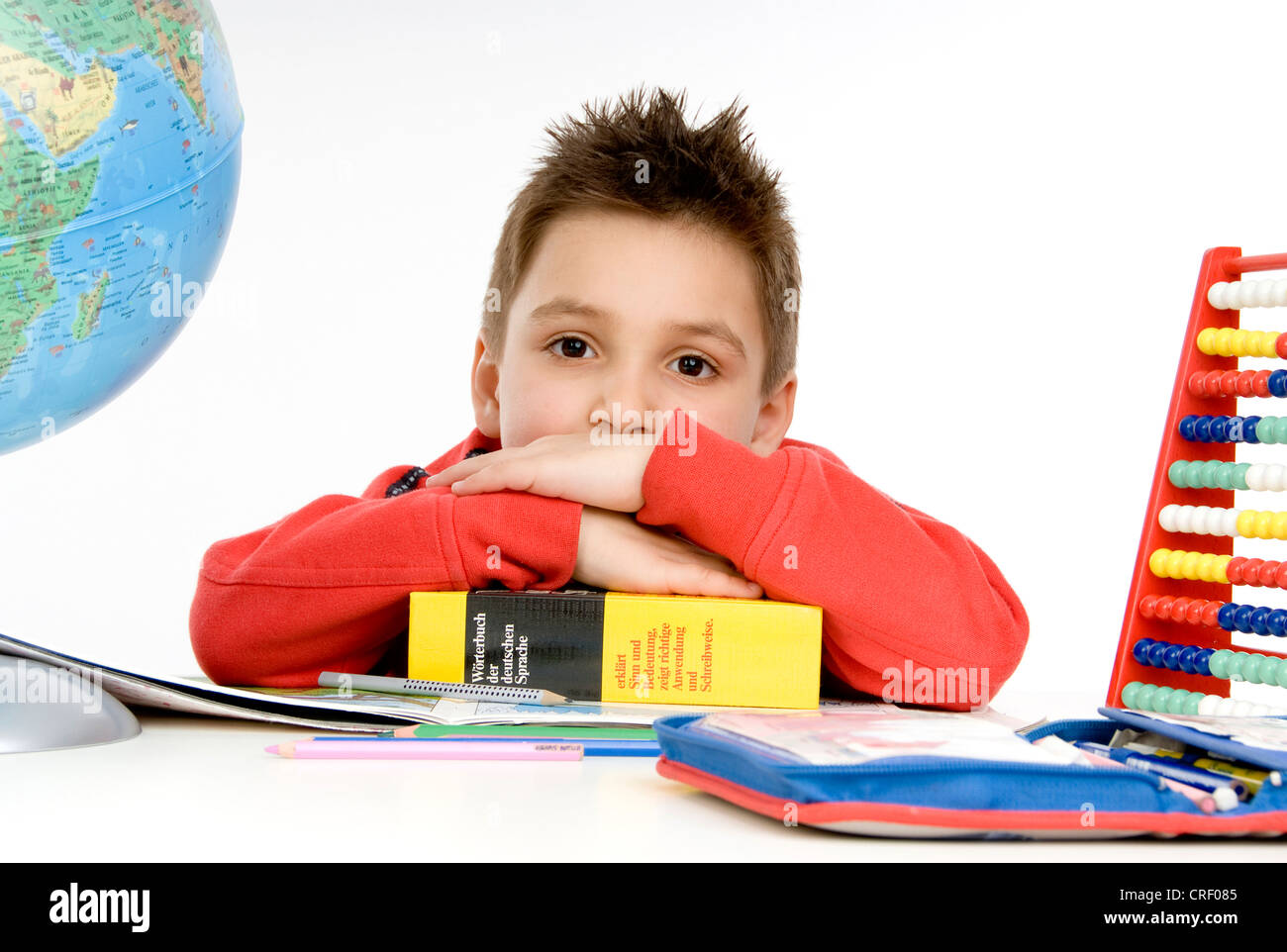 lazy schoolboy at desk Stock Photo Alamy