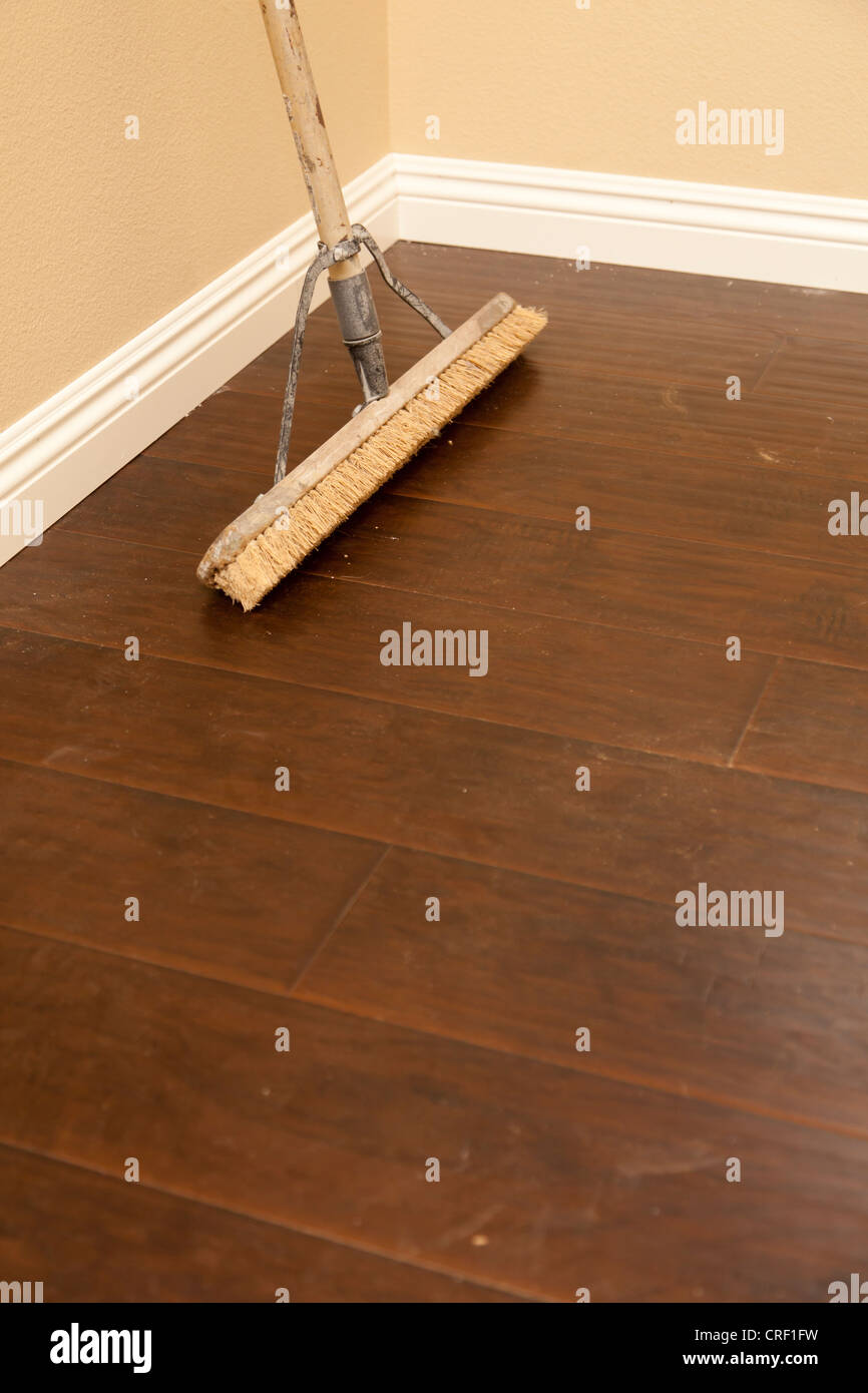 Push Broom on a Newly Installed Laminate Floor and New Baseboards Stock