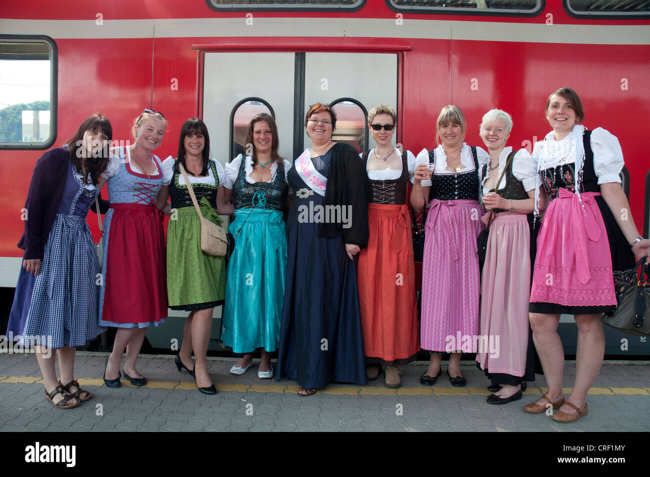 Young women wearing traditional Austrian or Bavarian costume returning home from a pre-wedding or 'hens' party' Stock Photo