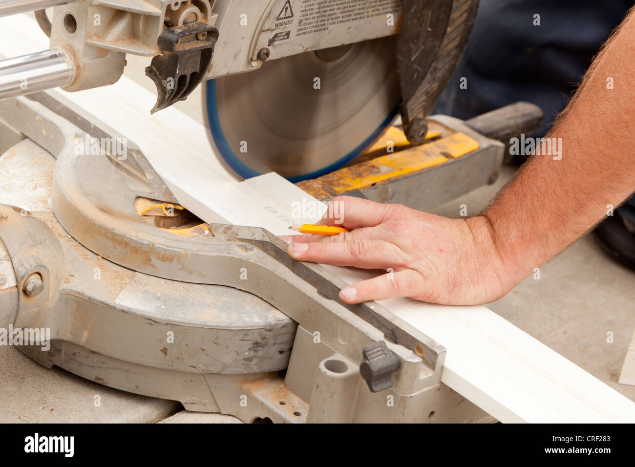 Contractor Using Circular Saw Cutting New Baseboard for Renovation