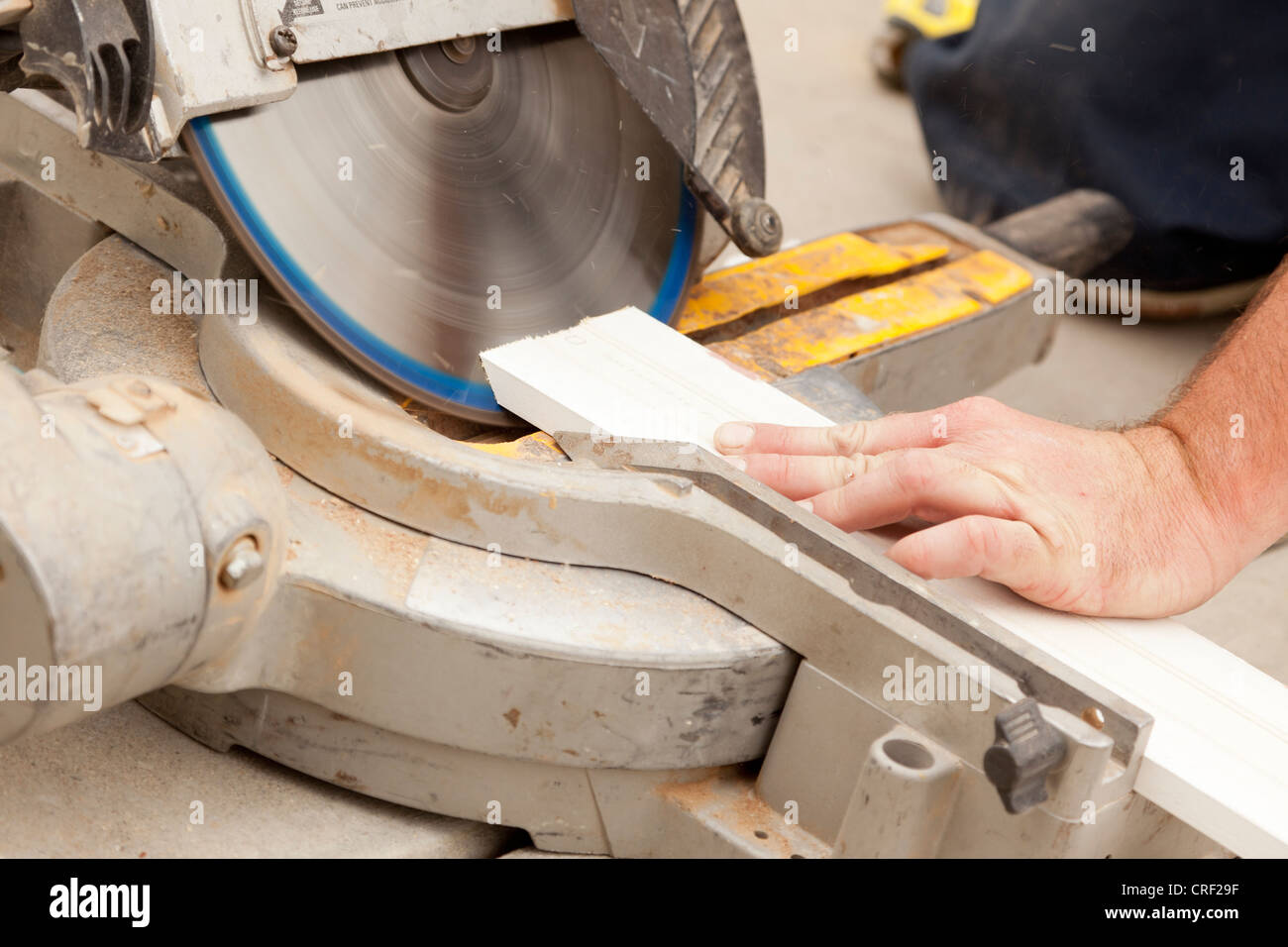 Contractor Using Circular Saw Cutting New Baseboard for Renovation