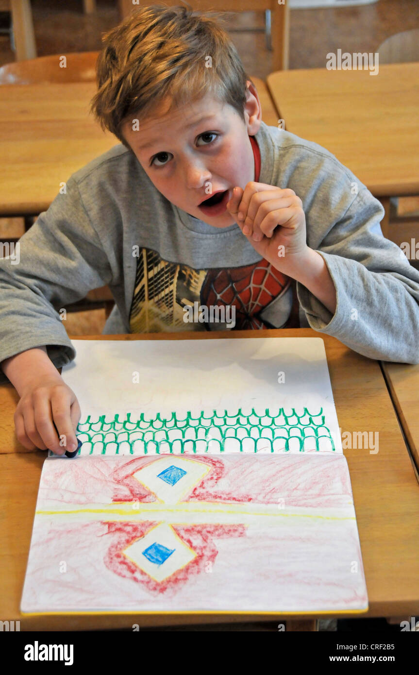 eight years old schoolboy drawing Stock Photo