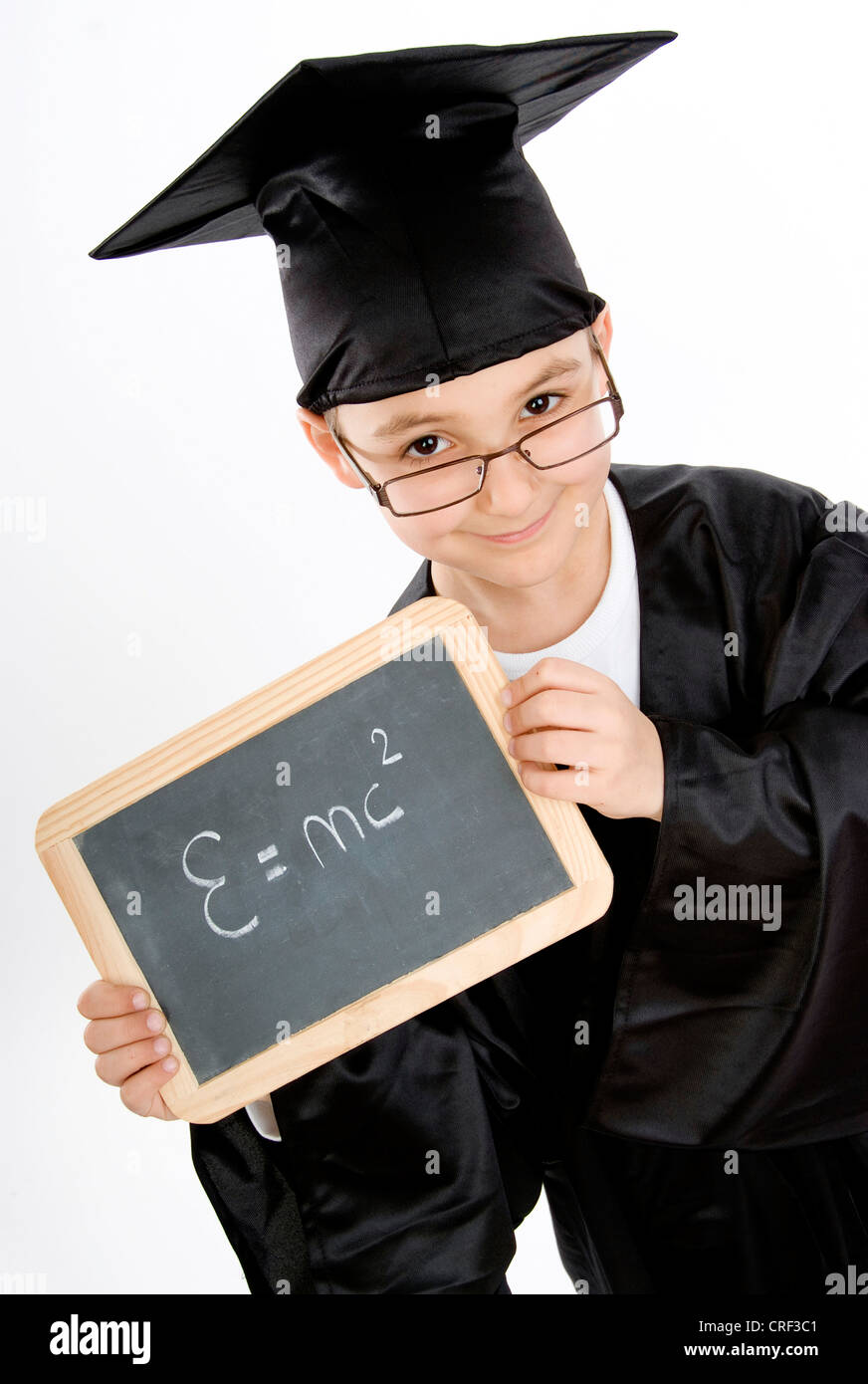 small boy as diploma holder with the theory of relativity on a blackboard Stock Photo
