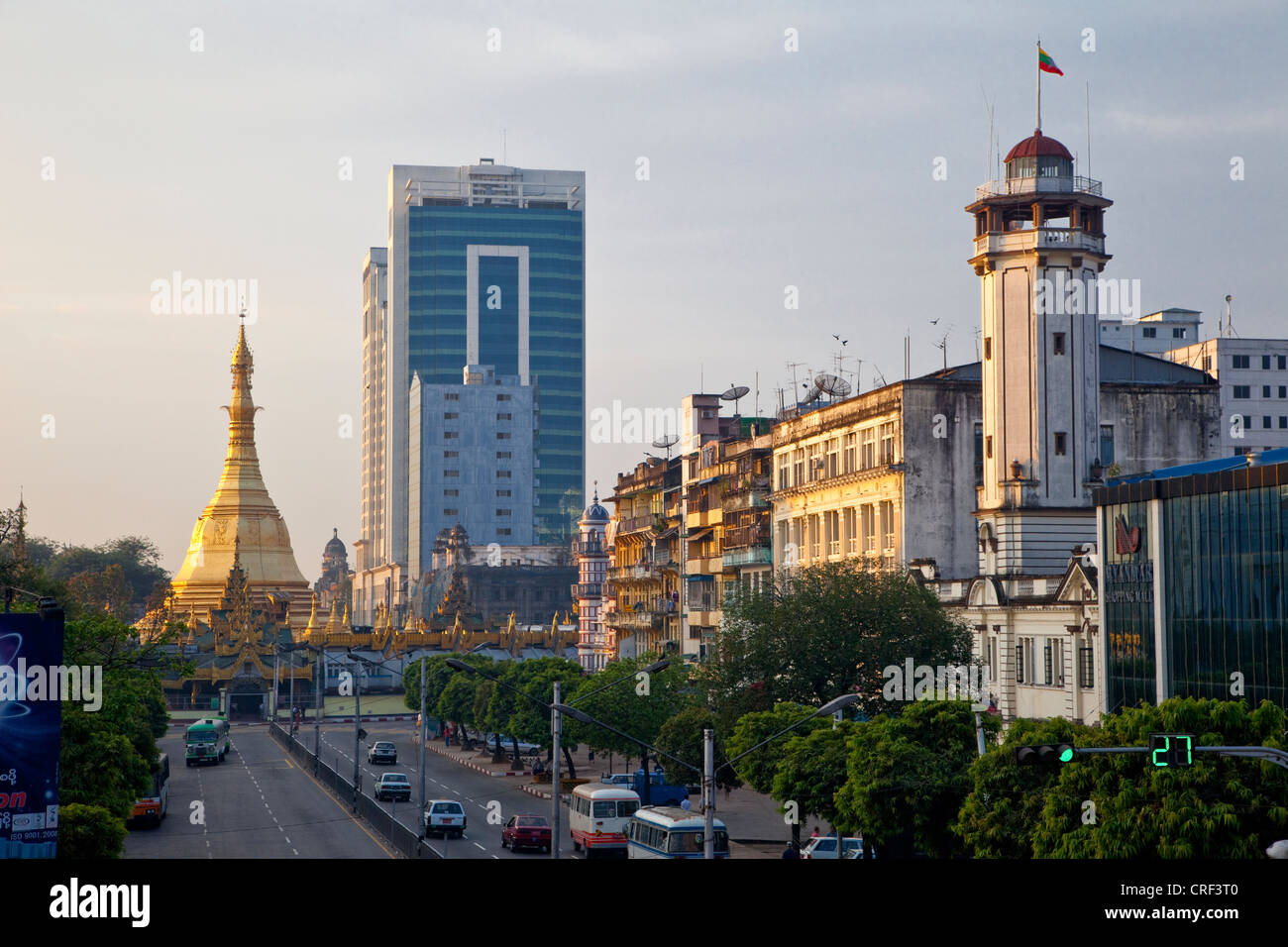 Myanmar, Burma, Yangon. Sule Pagoda Road, Early Morning.  Juxtaposition of Traditional and Modern Architectural Styles. Stock Photo