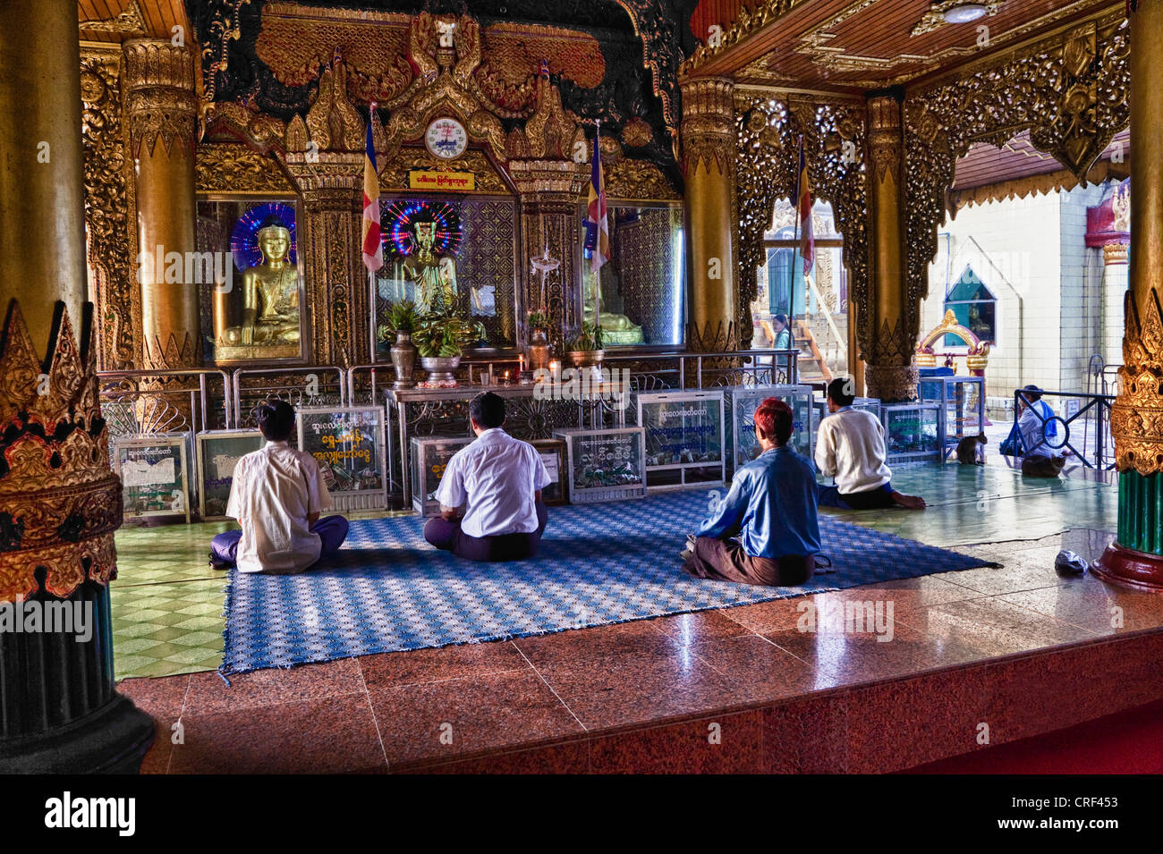 Myanmar, Burma, Yangon. Sule Pagoda, Early Morning Worshipers. Stock Photo