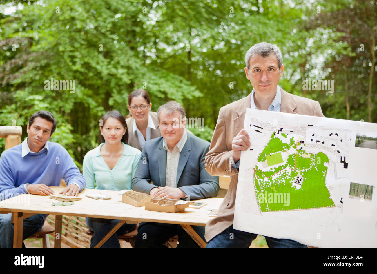 Businessman with map in meeting Stock Photo