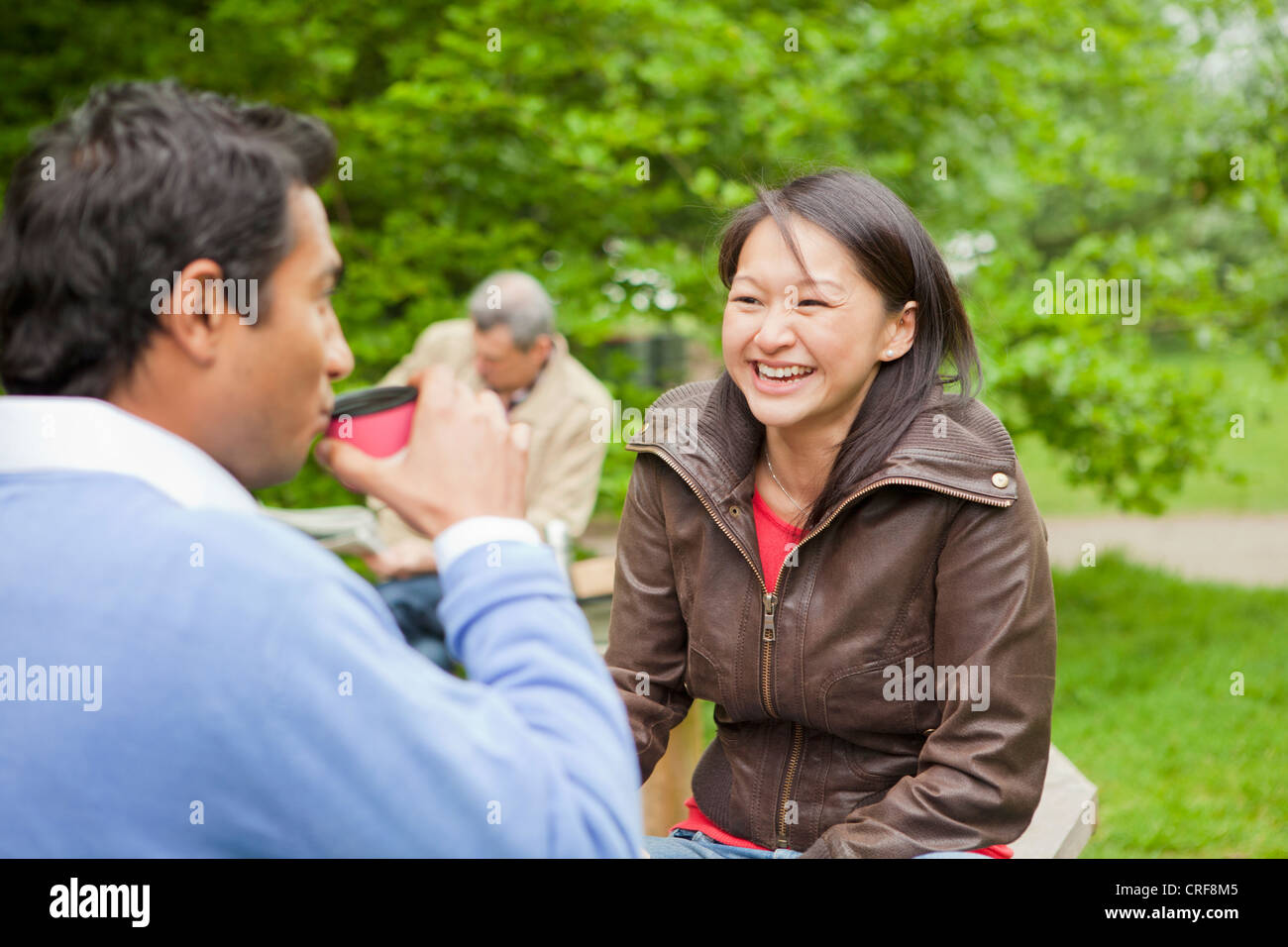 Couple having coffee in park Stock Photo