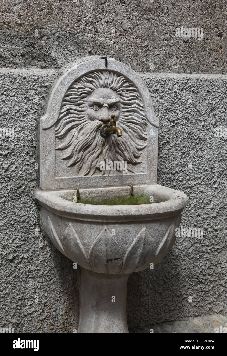 An Italian stone drinking trough or water tap Stock Photo
