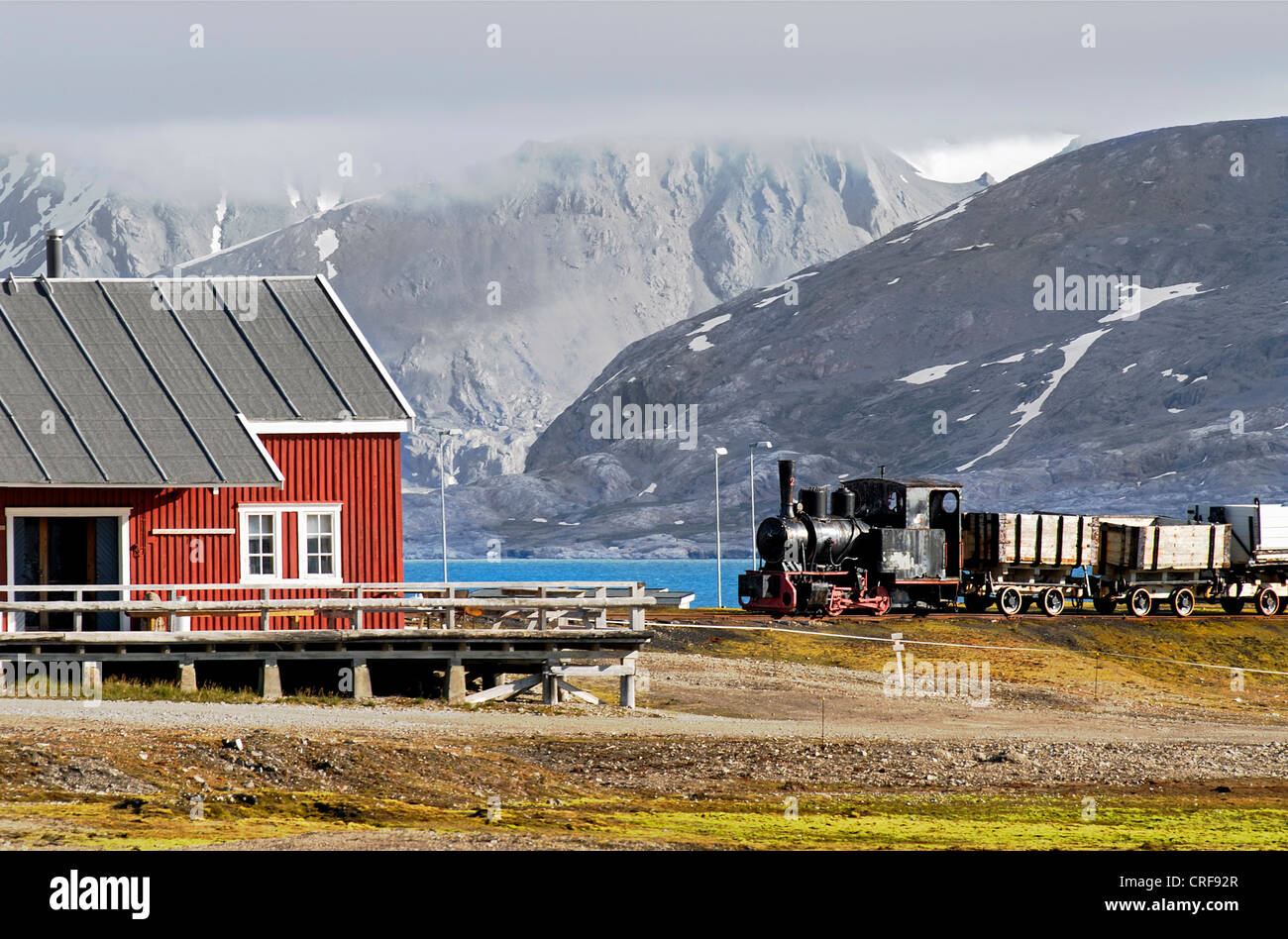 colourful house and a former coal train on display in the remote village of Ny Alesund, Norway, Svalbard Stock Photo