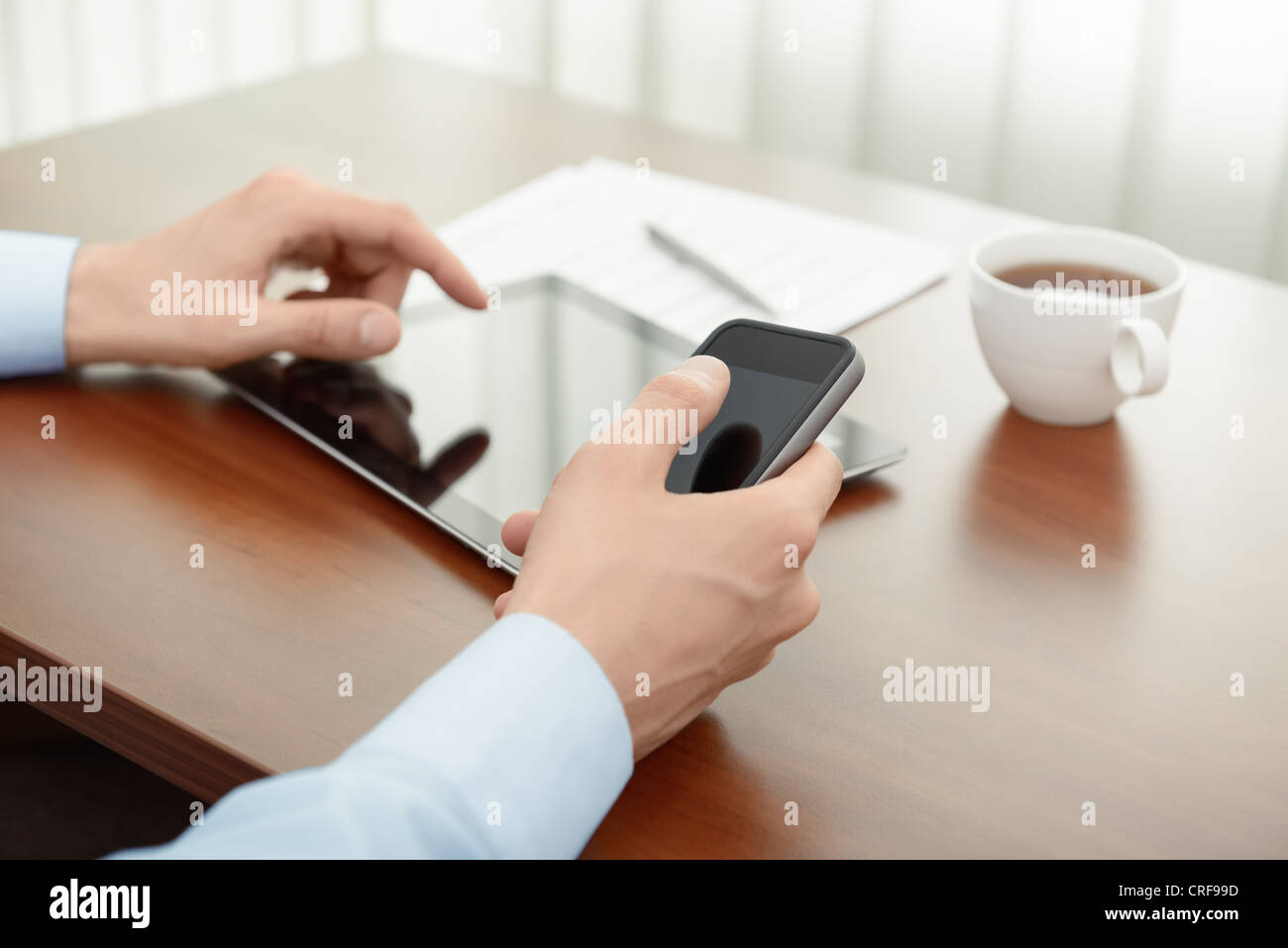 Businessman working with modern mobility devices at the office