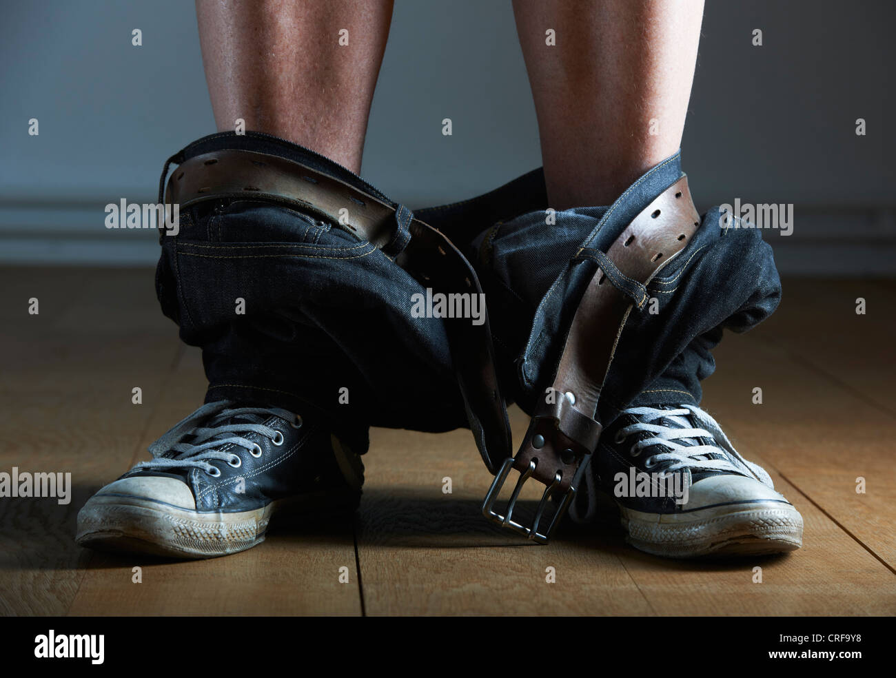 Mans jeans fallen around his ankles Stock Photo