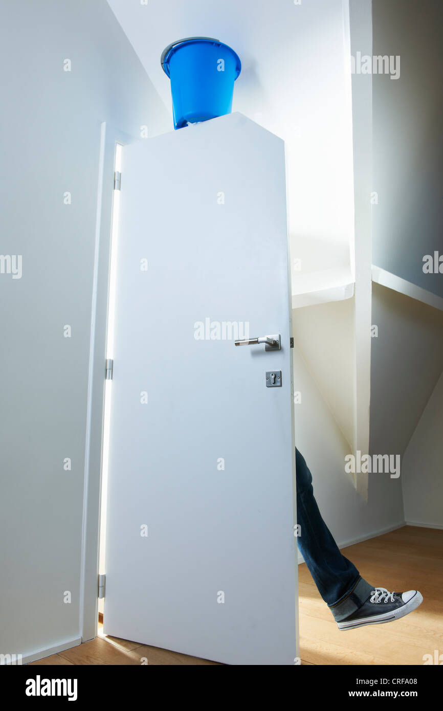 Person walking under booby trap Stock Photo