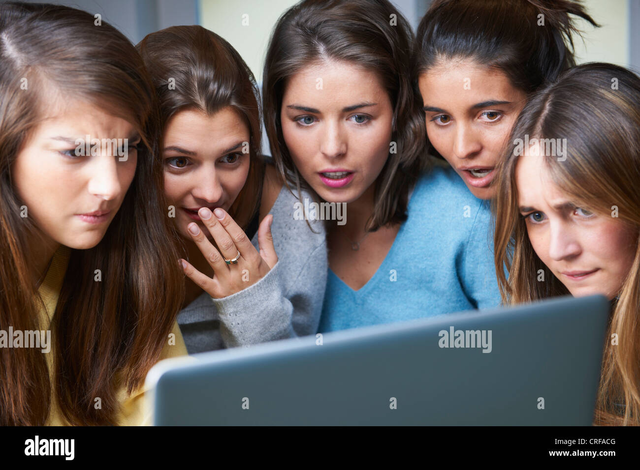 Shocked women using laptop together Stock Photo