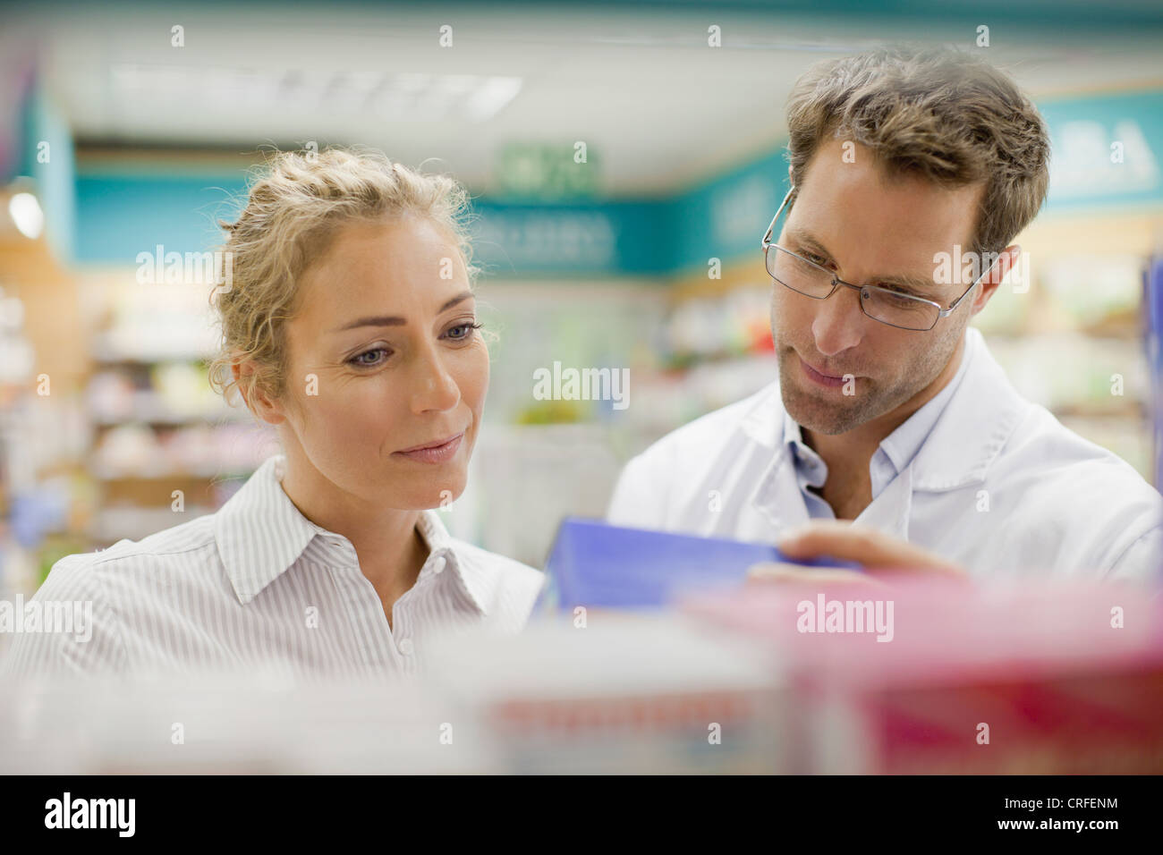 Pharmacist helping patient in store Stock Photo Alamy