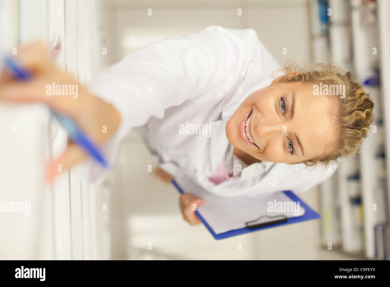 Pharmacist taking medicine on shelf Stock Photo Alamy