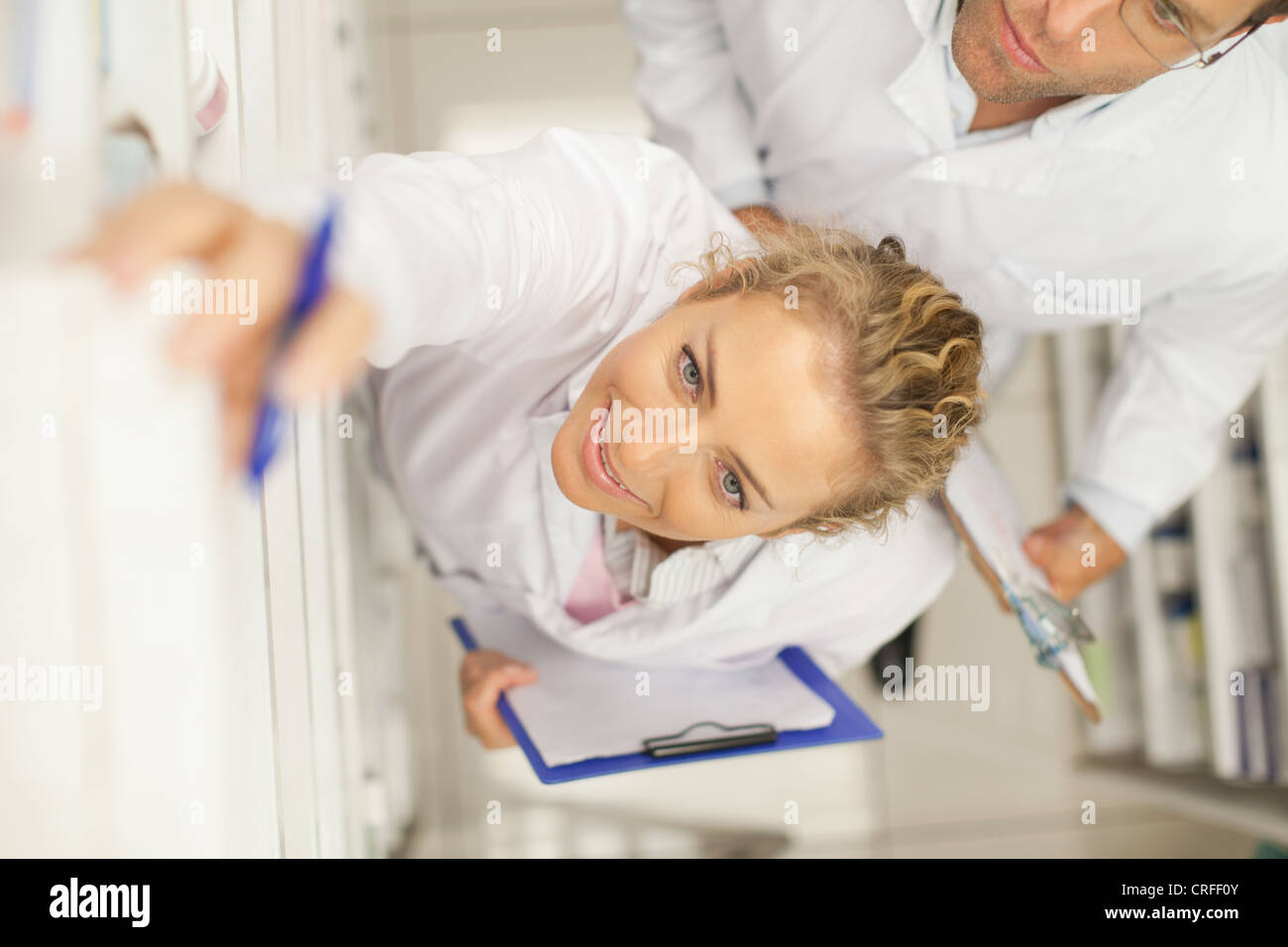 Pharmacist taking medicine on shelf Stock Photo Alamy