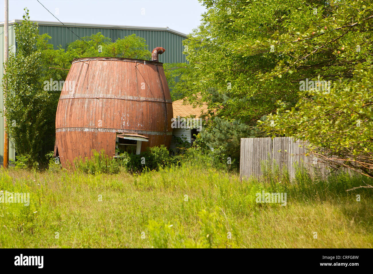 The Root Beer Barrel, a popular concession stand in the 1950's sits abandoned in an overgrown lot. Stock Photo