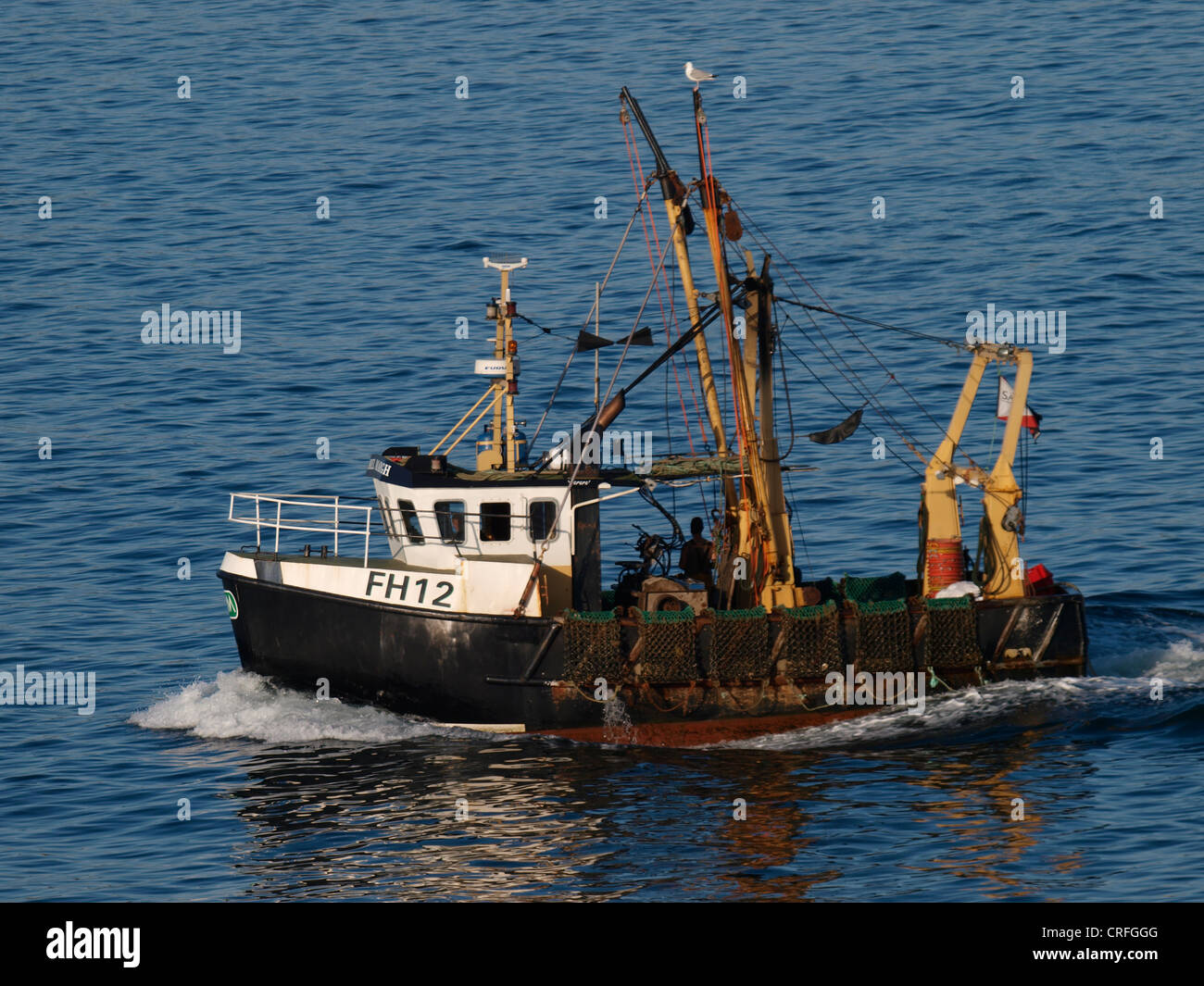 Commercial scallop dredging fishing trawler, Falmouth Bay, Cornwall, UK Stock Photo