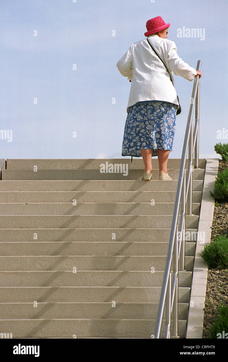 Potsdam, Germany, elderly woman climbing a staircase Stock Photo