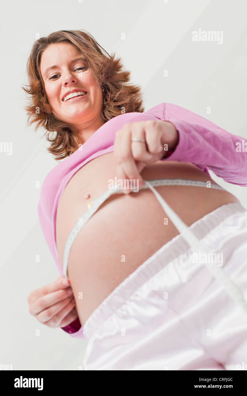 Woman measuring pregnant belly Stock Photo Alamy