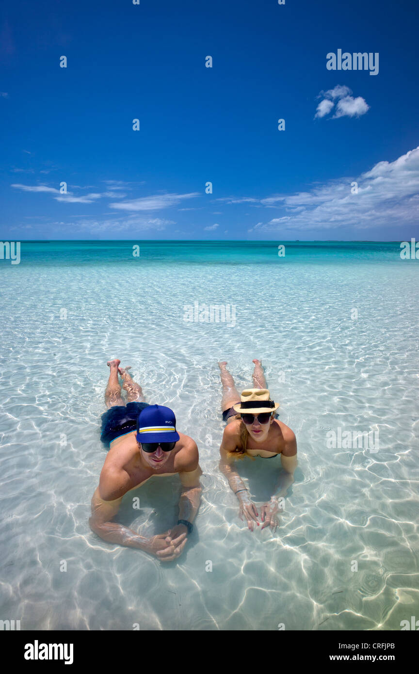 Couple in shallow water at Sapodilla Bay. Providenciales. Turks and Caicos. Stock Photo