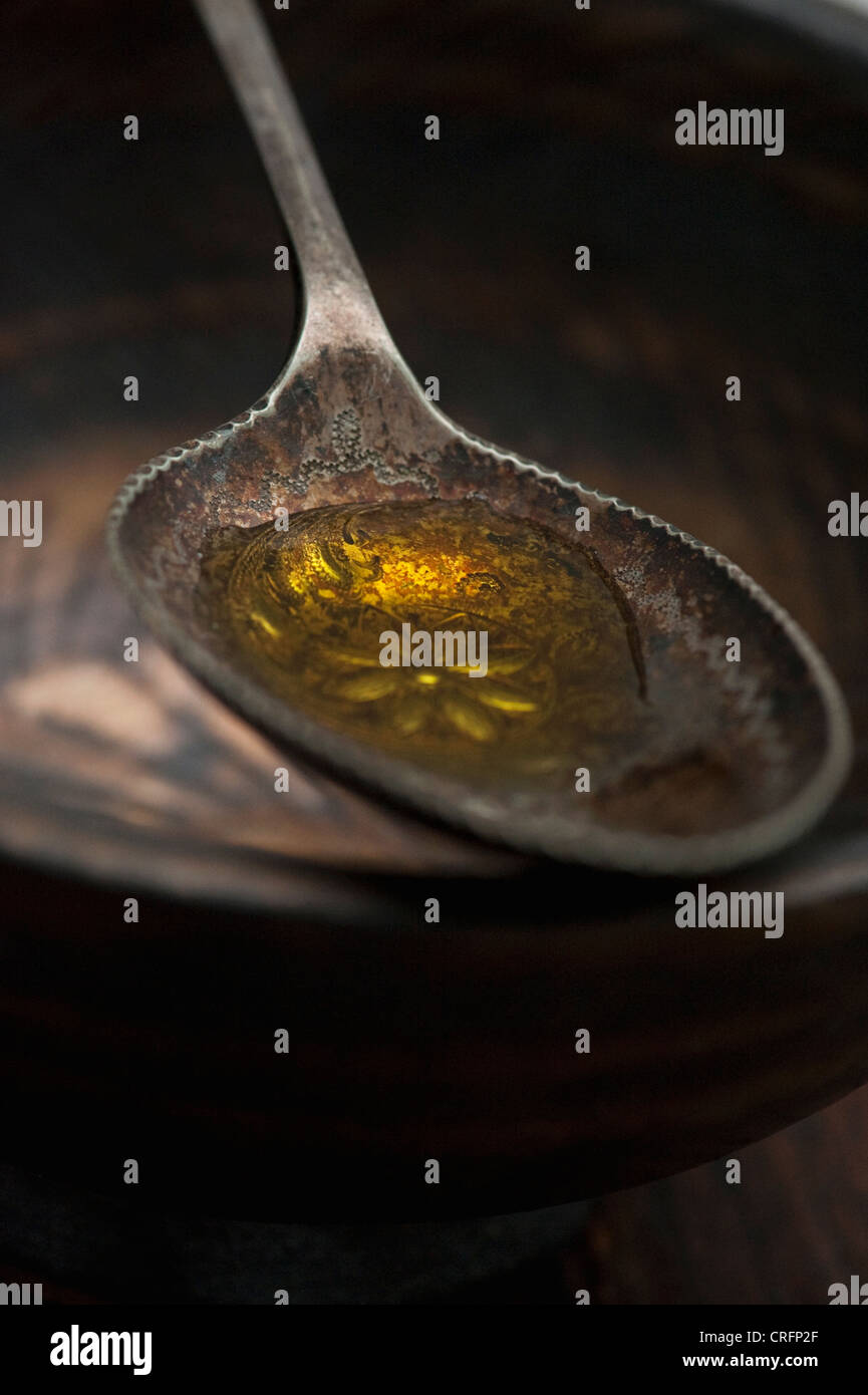 Close up of spoonful of olive oil Stock Photo