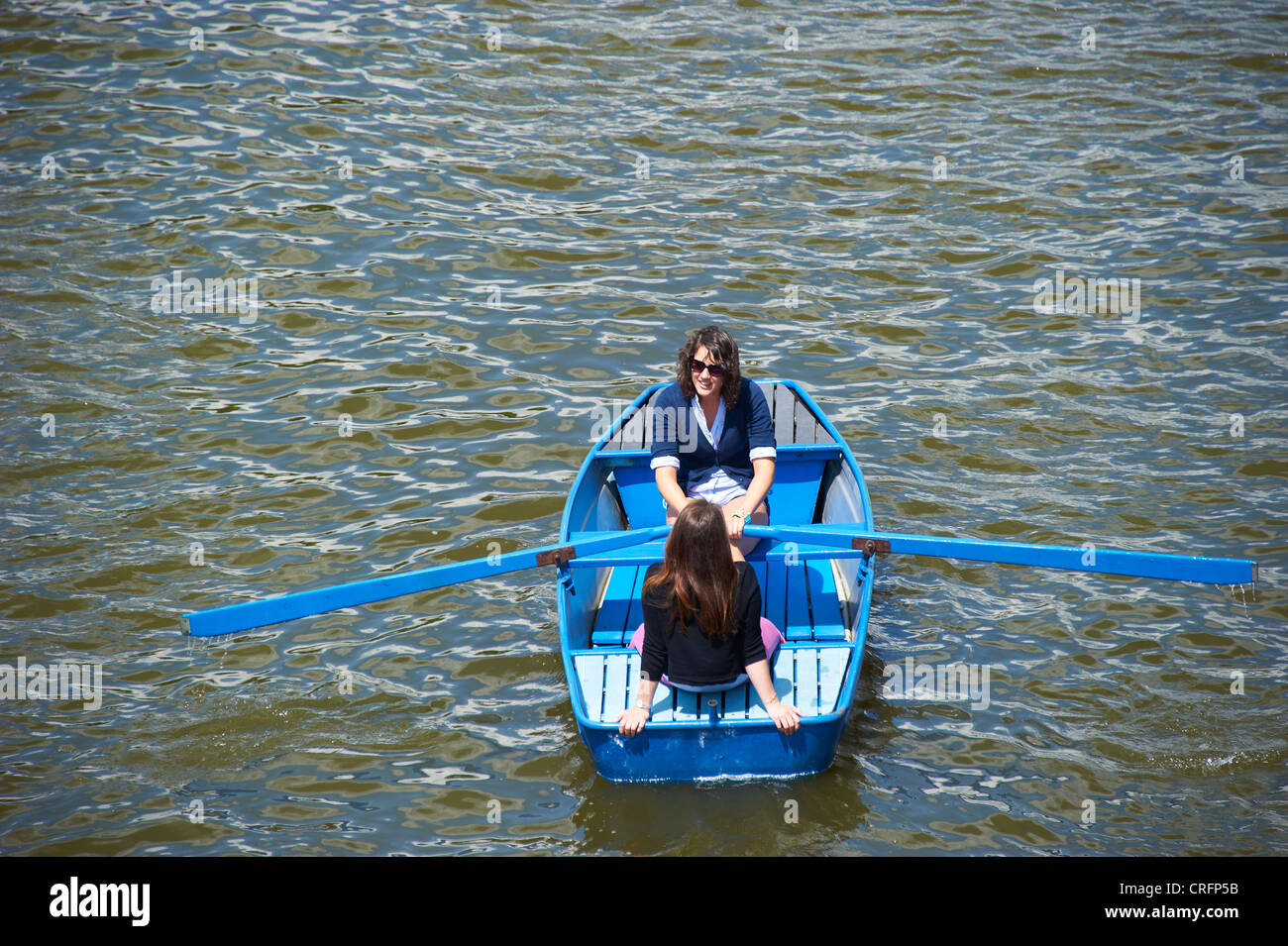 Pair of girls in boat. Paddler on the river Vltava, Prague Czech Republic Stock Photo
