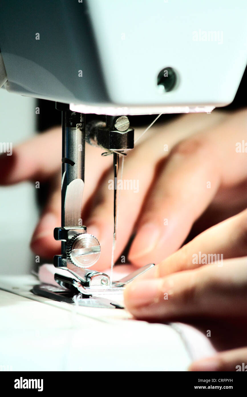 seamstress using sewing machine in their daily work Stock Photo