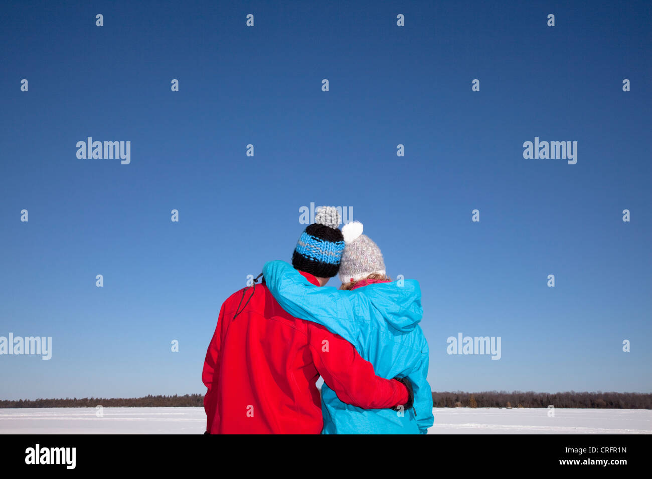 Couple hugging in snowy field Stock Photo - Alamy