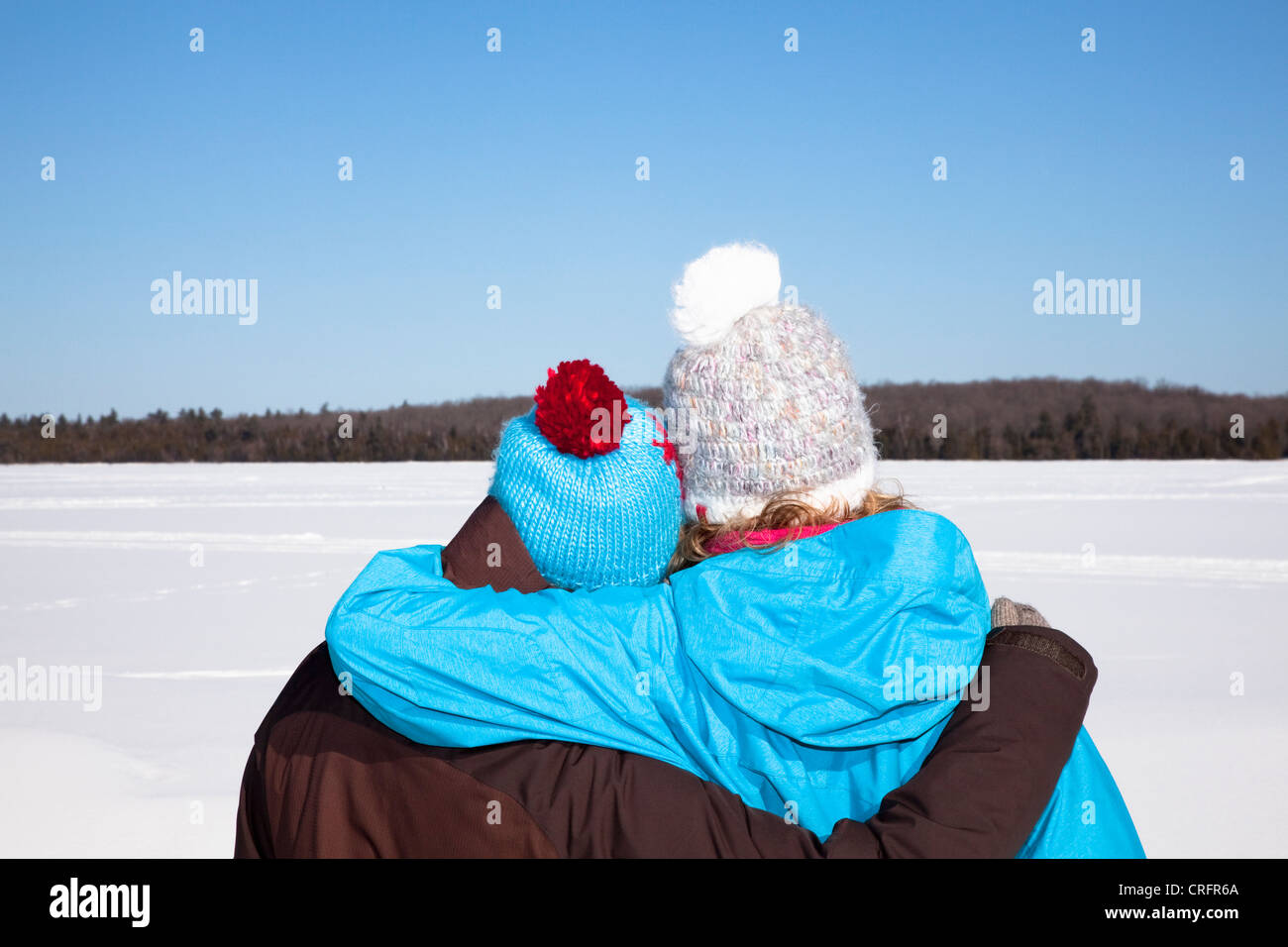 Couple hugging in snowy field Stock Photo - Alamy