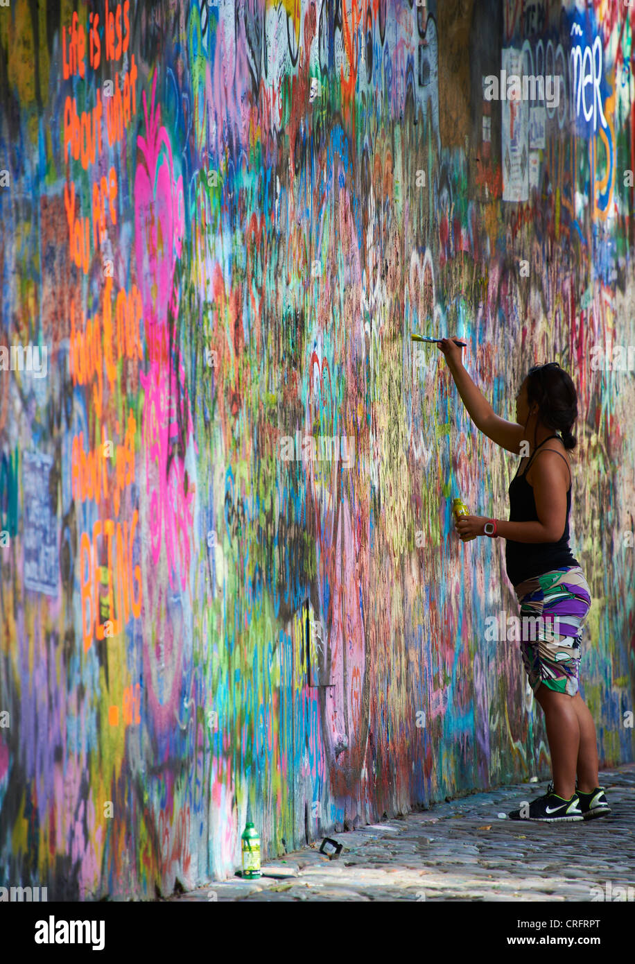 The John Lennon graffiti Wall in Prague, Czech Republic, tourist woman