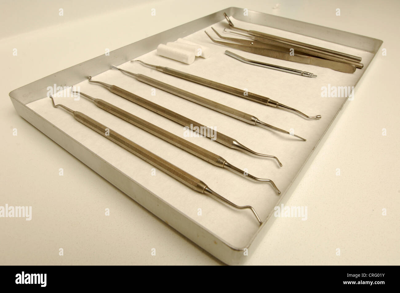 A tray of dental equipment including dental picks, scrapers and an angled mirror. Stock Photo