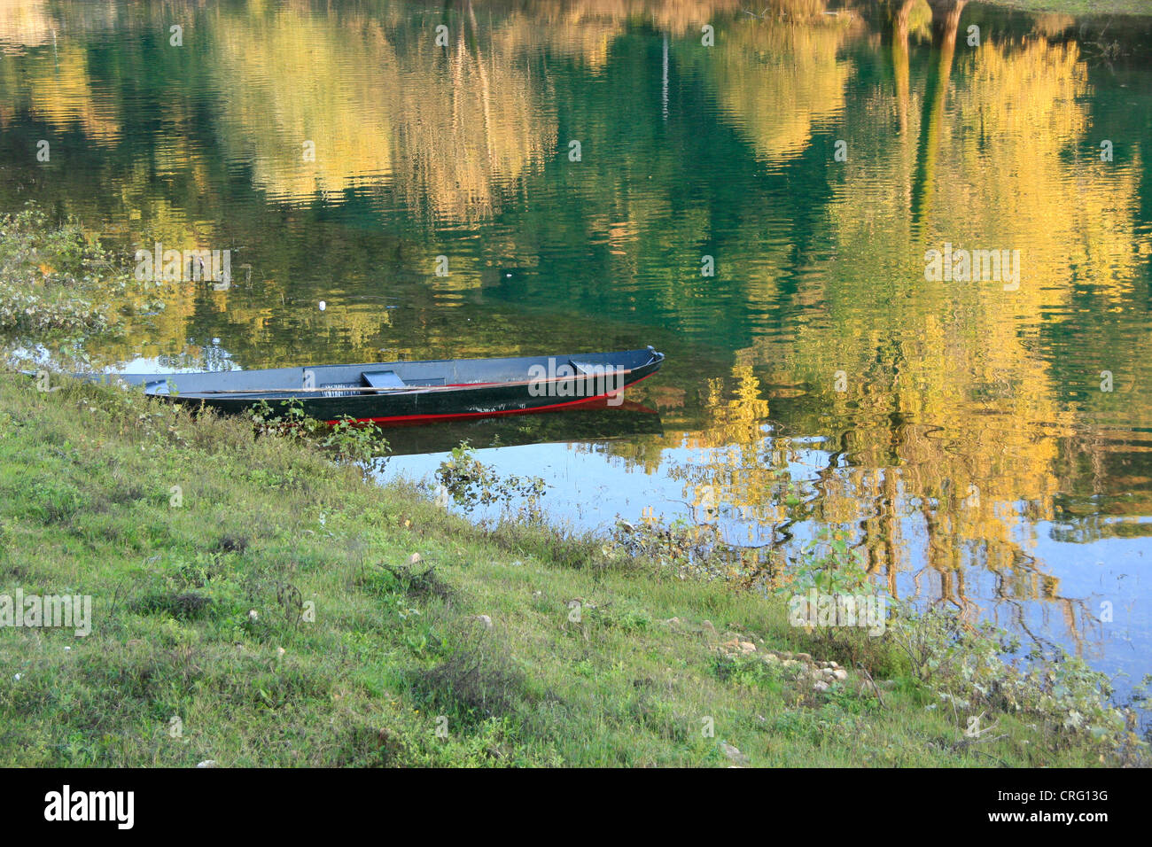 Small boat on river with fall colours, Rijeka Crnojevica, Cetinje, Montenegro Stock Photo