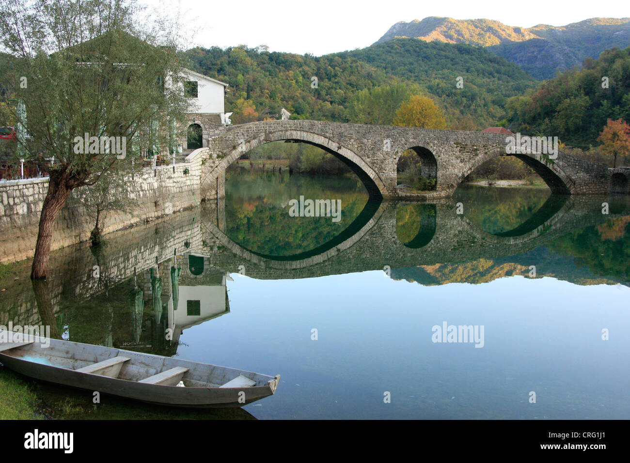 Old boat and stone bridge, Rijeka Crnojevica, Cetinje, Montenegro Stock Photo