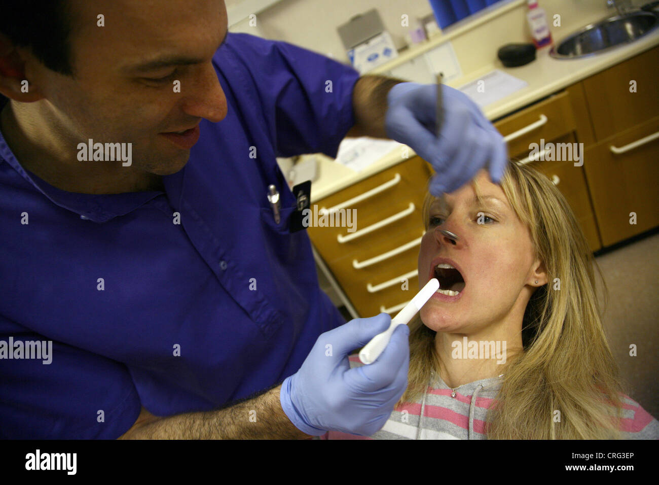 Dentist checking patients teeth Stock Photo Alamy