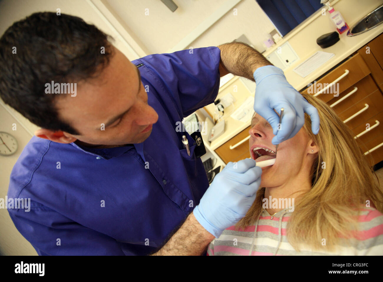 Dentist checking patients teeth Stock Photo Alamy