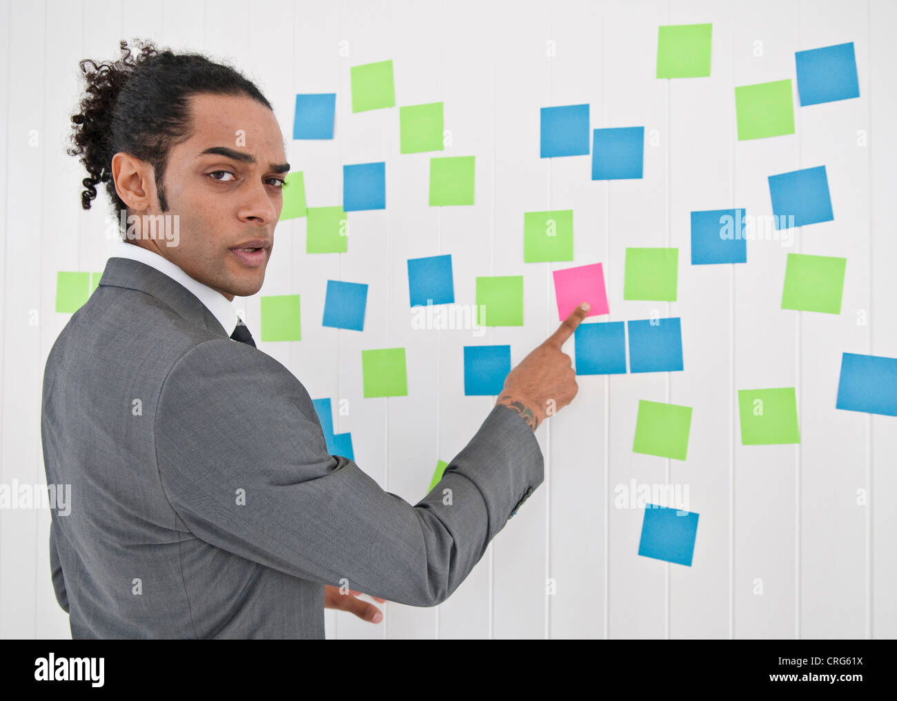 Businessman pointing to sticky note Stock Photo