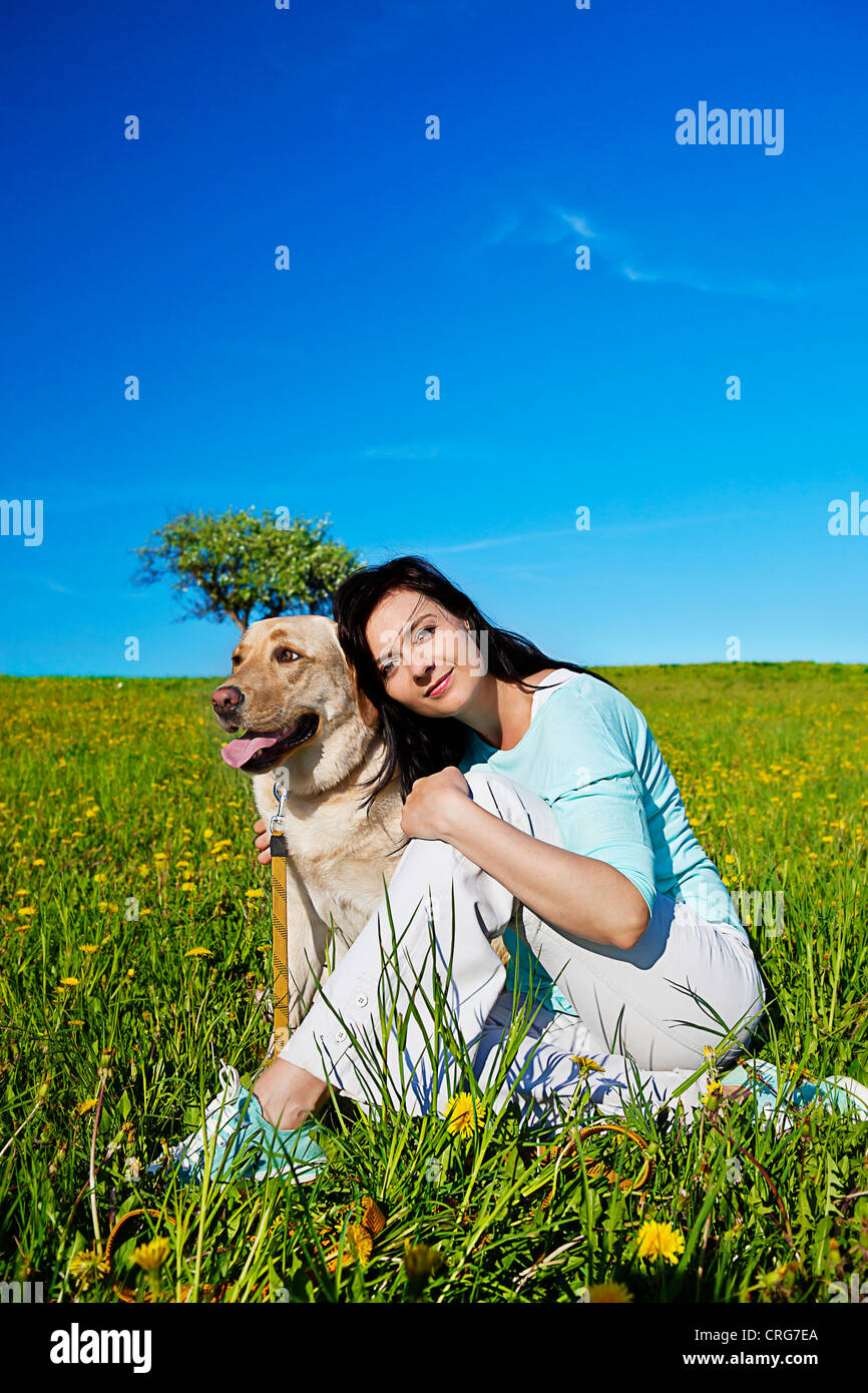 a girl with her dog in the meadow Stock Photo - Alamy
