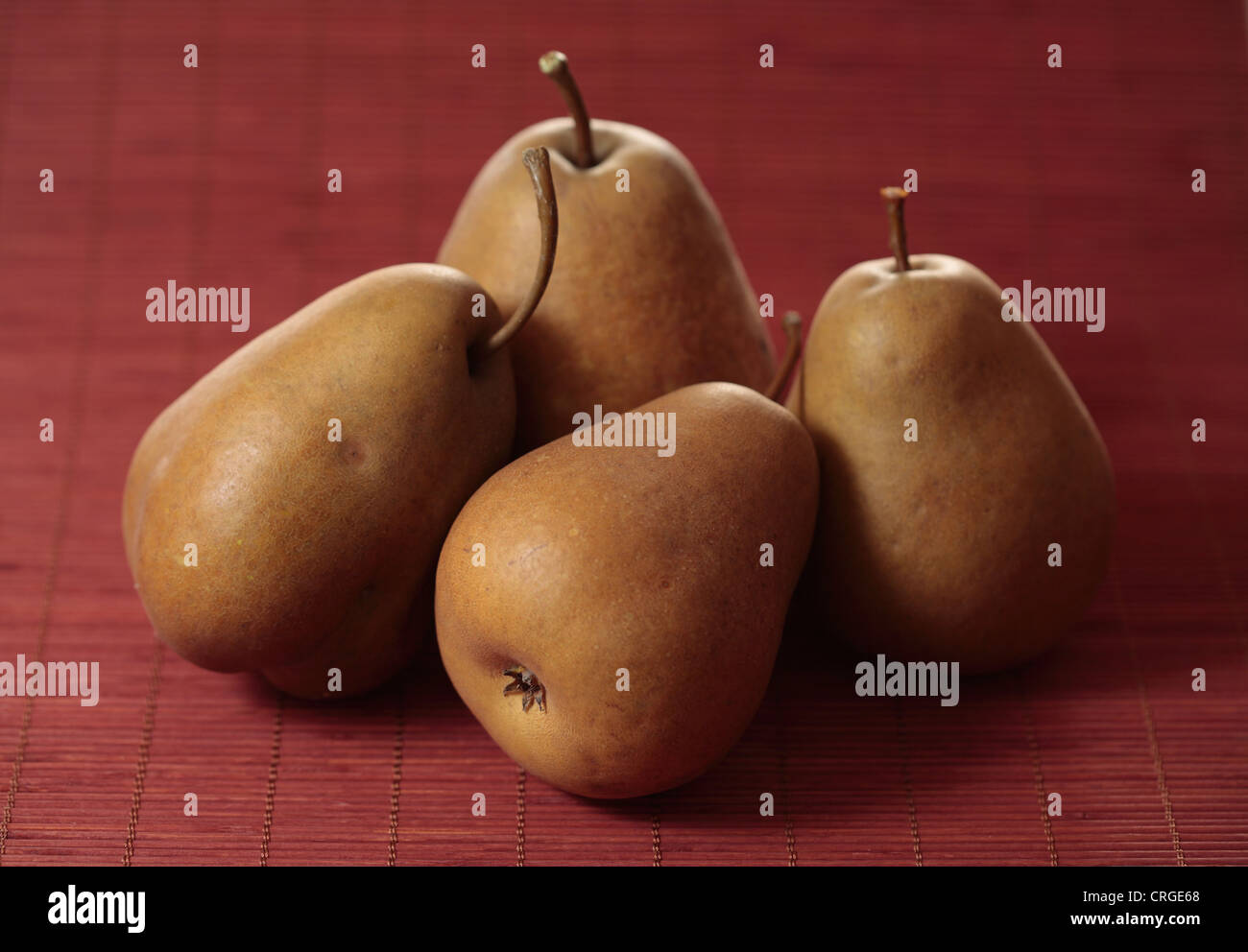 Four pears on red background Stock Photo