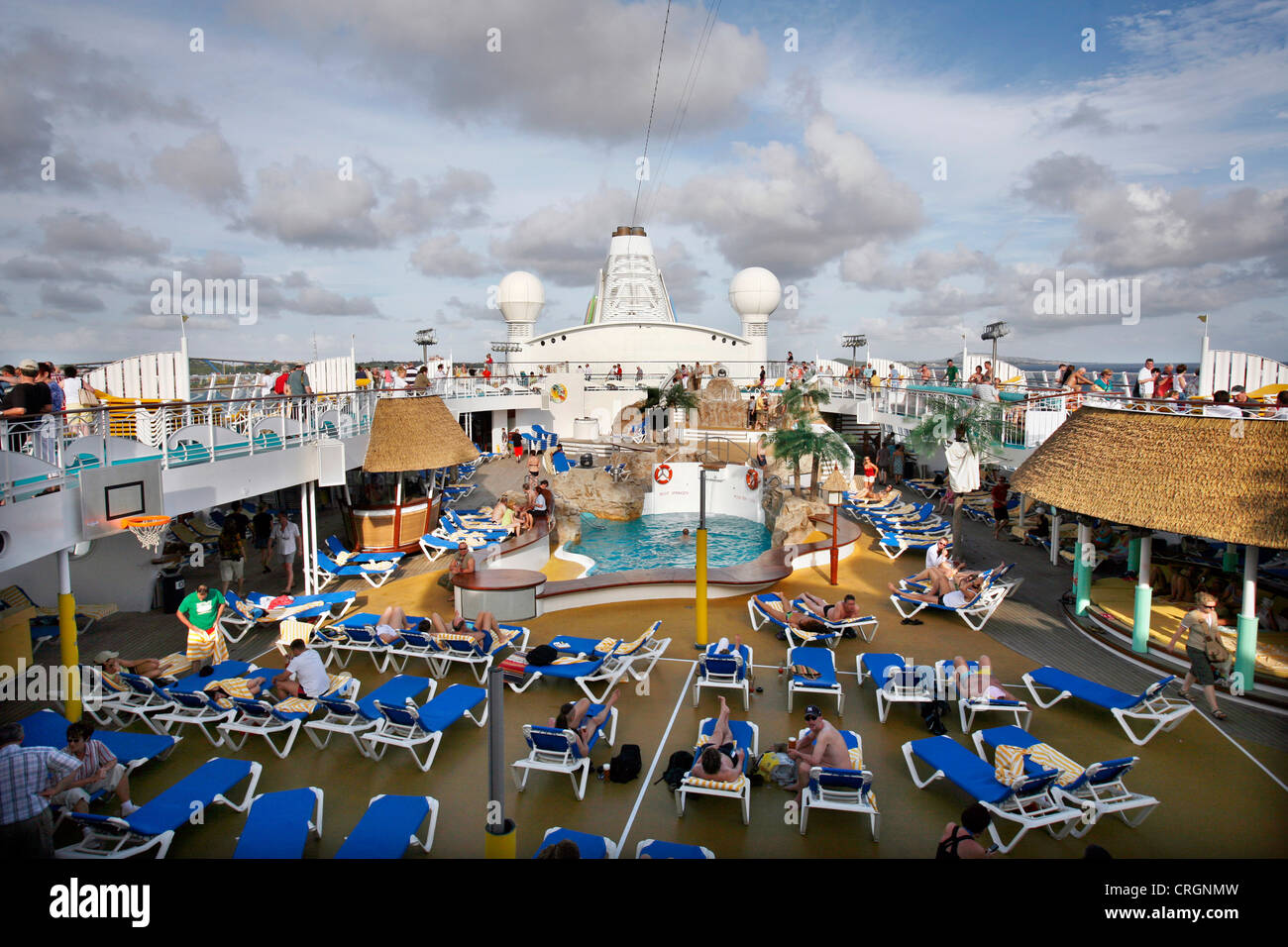 upper deck with canvas chairs and swimming pool on a cruise liner Stock Photo